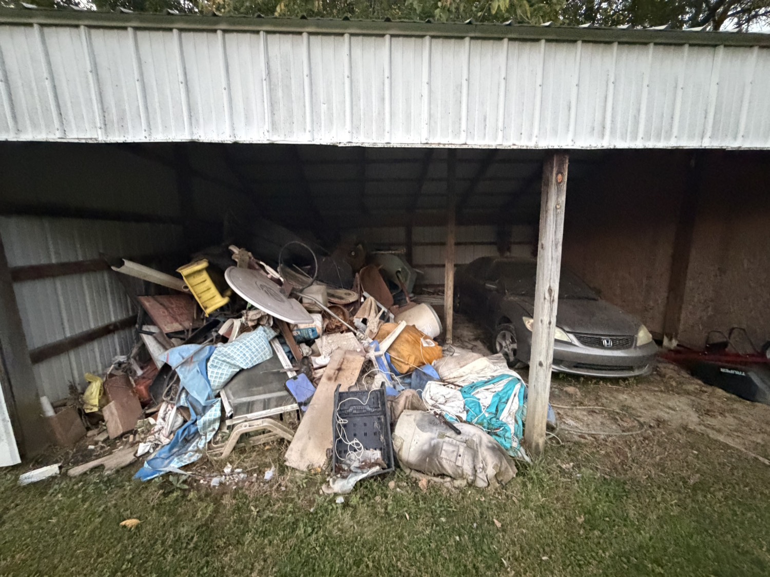 Before - garage exterior pile of junk